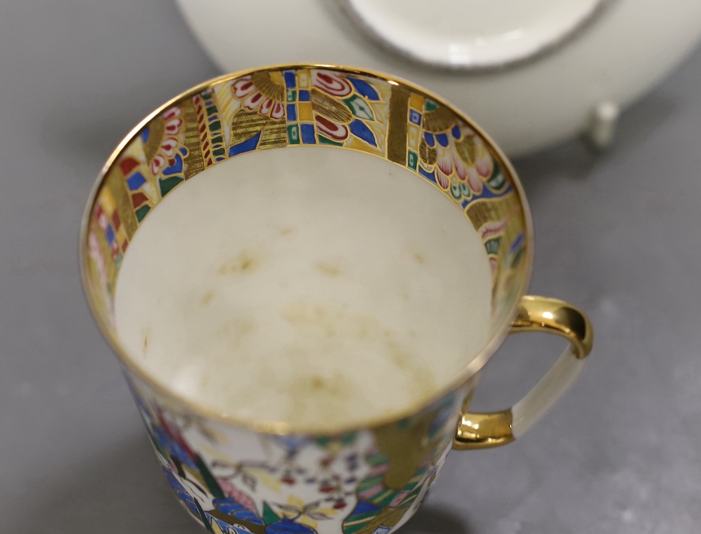 A Russian gilt enamel porcelain tea cup and saucer, cup 8cms high